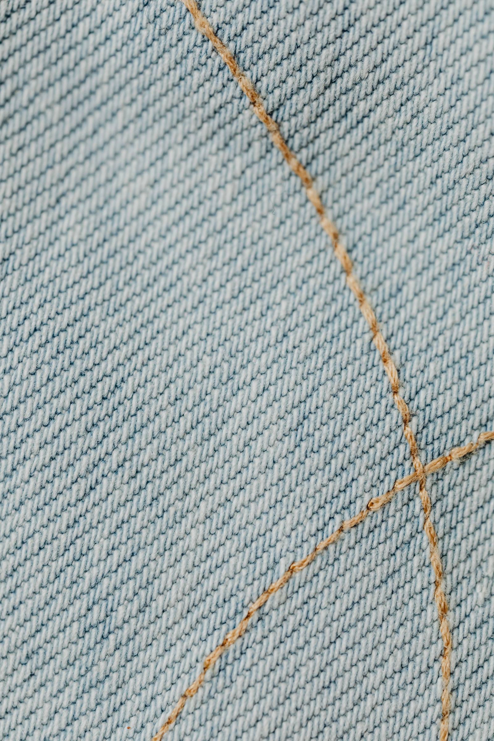 Close-up of stitching on denim fabric